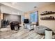 Open living area with wood-look floors, a couch, and a TV at 9790 Overlook Ridge Ave, Las Vegas, NV 89148