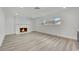 Cozy living room with brick fireplace, modern lighting, and large window view at 1501 Strong Dr, Las Vegas, NV 89102