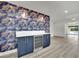 Living room showcasing a built-in wine fridge set against a striking wallpaper accent wall at 1501 Strong Dr, Las Vegas, NV 89102