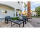 Seating area on backyard patio with artificial turf at 2108 Grand Island Ct, Las Vegas, NV 89117