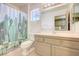 Bathroom with a cactus-themed shower curtain, neutral-toned walls, and white porcelain toilet at 3013 Sungold Dr, Las Vegas, NV 89134