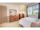 Bedroom with a large window and view of the yard and trees in the backyard at 3013 Sungold Dr, Las Vegas, NV 89134