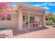 Side view of an inviting home featuring covered patio with chairs, desert landscaping and tiled roof at 3013 Sungold Dr, Las Vegas, NV 89134