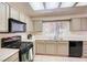 Well-lit kitchen features tile floors, and a window view of plants at 3013 Sungold Dr, Las Vegas, NV 89134