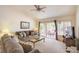 Cozy living room with plush seating, ceiling fan, and sliding glass door to an outdoor patio at 3013 Sungold Dr, Las Vegas, NV 89134
