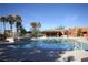 Beautiful pool offering a serene and luxurious experience, surrounded by palm trees and a charming clubhouse at 565 Fairways Dr, Mesquite, NV 89027