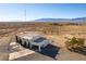 Aerial view of two story house with attached garage, and expansive desert landscape at 3490 S Adobe Ct, Pahrump, NV 89048