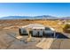 Two-story house with attached garage and large yard in a desert setting at 3490 S Adobe Ct, Pahrump, NV 89048