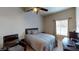 Cozy bedroom with a queen-size bed, a ceiling fan, and a window with natural light at 3490 S Adobe Ct, Pahrump, NV 89048