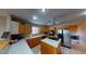 Kitchen boasts an island with a cooktop, stainless steel appliances, and ample counter space at 3490 S Adobe Ct, Pahrump, NV 89048