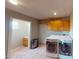 Laundry room with washer, dryer, cabinets, and extra space at 3490 S Adobe Ct, Pahrump, NV 89048