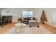 Living room features a gray sectional sofa, coffee table, and hardwood floors at 1420 Vegas Valley Dr # 18, Las Vegas, NV 89169