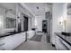 Luxurious bathroom with marble walls, dual vanities, soaking tub, and modern lighting fixtures at 500 Overlook Rim Dr, Henderson, NV 89012