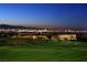 Expansive home overlooking a manicured golf course and the dazzling city skyline at twilight at 500 Overlook Rim Dr, Henderson, NV 89012