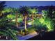 Night view of the grand circular driveway, lined with lush palm trees and manicured landscaping at 500 Overlook Rim Dr, Henderson, NV 89012