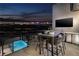 Stunning outdoor patio with a built-in grill, dining area, and city views at night at 500 Overlook Rim Dr, Henderson, NV 89012