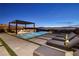 Backyard oasis featuring a pool, outdoor lounge, and panoramic city skyline views at 500 Overlook Rim Dr, Henderson, NV 89012