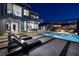 Luxurious outdoor living with an infinity pool, lounge area, and elegant patio furniture at 500 Overlook Rim Dr, Henderson, NV 89012