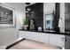 Contemporary powder room with black marble accent wall, sleek vanity, and elegant lighting at 500 Overlook Rim Dr, Henderson, NV 89012