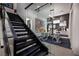 Modern staircase leading to a stylish office with glass walls and contemporary furniture at 500 Overlook Rim Dr, Henderson, NV 89012