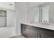 Stylish bathroom showcasing a double sink vanity and large mirror, complemented by neutral tones at 9002 Shifting Skye St, Las Vegas, NV 89166