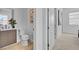 Well lit bathroom with wood floors, white walls, and a modern vanity at 9002 Shifting Skye St, Las Vegas, NV 89166