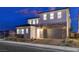 Two-story house with stone and light-colored exterior at dusk at 9002 Shifting Skye St, Las Vegas, NV 89166