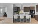 Contemporary kitchen featuring stainless steel appliances, a waterfall island, and modern dark brown cabinets at 9002 Shifting Skye St, Las Vegas, NV 89166