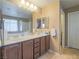 Double sink bathroom with dark brown vanity and large mirror at 10260 Danskin Dr, Las Vegas, NV 89166