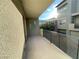 A modern balcony with sleek railings offers outdoor space with views of nearby trees and buildings at 11236 Rainbow Peak Ave # 210, Las Vegas, NV 89135