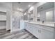 Elegant bathroom featuring double vanity and marble shower at 1761 Moose St, Pahrump, NV 89048