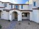 Charming townhome with stucco exterior, covered porch, and desert landscaping at 2723 Luzzi Walk, Henderson, NV 89044