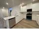 Modern kitchen features white cabinets, stainless steel appliances, and a breakfast bar at 2723 Luzzi Walk, Henderson, NV 89044
