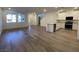 Bright, open-concept living space with wood floors seamlessly connected to the kitchen at 2723 Luzzi Walk, Henderson, NV 89044