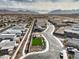 Expansive aerial shot showing home with adjacent green space, desert community, and distant mountains at 617 Sylvan St, Henderson, NV 89002