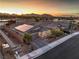 Stunning aerial view of a single-story home featuring solar panels and desert landscaping at sunset at 617 Sylvan St, Henderson, NV 89002