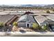 Aerial view of a home showcasing its solar panels, desert landscaping, and proximity to neighborhood amenities at 617 Sylvan St, Henderson, NV 89002