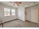 Cozy bedroom featuring a ceiling fan, two windows, and a closet at 617 Sylvan St, Henderson, NV 89002
