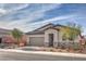 Charming single-story home features stone accents, desert landscaping, and a two-car garage at 617 Sylvan St, Henderson, NV 89002