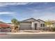 Single-story home with gray garage door and stone accents at 617 Sylvan St, Henderson, NV 89002