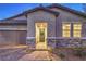Charming exterior view highlighting the front door with stone accents, a welcoming wreath, and desert landscaping at 617 Sylvan St, Henderson, NV 89002