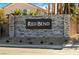 Community entrance sign with a stacked stone wall that reads 'Red Bend' and a nicely landscaped setting at 6574 Tumoulin St, Las Vegas, NV 89148