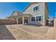 An open backyard area with gravel and covered patio provides a blank canvas for outdoor living at 9881 Lost Horse Ave, Las Vegas, NV 89178