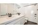 Modern bathroom featuring dual sinks, white countertops, and a tiled shower and tub at 9881 Lost Horse Ave, Las Vegas, NV 89178