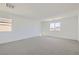 Spacious bedroom with plush carpet, neutral walls, and bright natural light at 9881 Lost Horse Ave, Las Vegas, NV 89178