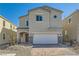 Charming two-story home with a two car garage, paved driveway, and stone accents at 9881 Lost Horse Ave, Las Vegas, NV 89178