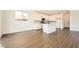 Open kitchen with white cabinets, island, and stainless steel appliances with a view to backyard at 9881 Lost Horse Ave, Las Vegas, NV 89178