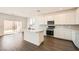 Modern kitchen boasts white cabinets, stainless steel appliances, and a center island at 9881 Lost Horse Ave, Las Vegas, NV 89178
