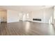 Bright living room featuring modern wood flooring and a stylish linear fireplace at 9881 Lost Horse Ave, Las Vegas, NV 89178