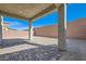 Spacious covered patio area with brick pavers and privacy wall at 9881 Lost Horse Ave, Las Vegas, NV 89178